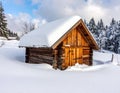Wooden cabin in a snowy landscape, surrounded by snow-covered trees, creating a serene winter scene Royalty Free Stock Photo