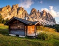 Log cabin set against the stunning backdrop of the Dolomite Mountains in Italy Royalty Free Stock Photo