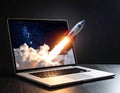 A rocket is launching out of a laptop screen, with a vibrant image of space, stars, and clouds displayed on the monitor Royalty Free Stock Photo