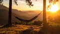 Sunset with hammock in silhouette shadow with orange light effect. Royalty Free Stock Photo