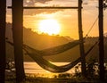 Sunset with hammock in silhouette shadow with orange light effect. Royalty Free Stock Photo