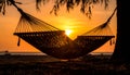Sunset with hammock in silhouette shadow with orange light effect. Royalty Free Stock Photo