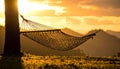 Sunset with hammock in silhouette shadow with orange light effect. Royalty Free Stock Photo