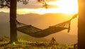 Sunset with hammock in silhouette shadow with orange light effect. Royalty Free Stock Photo