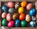 Colorful, intricately patterned Easter eggs nestled in a wooden tray Royalty Free Stock Photo