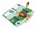 A stack of three 100 Euro banknotes is topped with a decorative miniature rolling pin Royalty Free Stock Photo