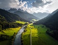 Lush green valley landscape with meandering river surrounded by forested mountains Royalty Free Stock Photo