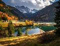 Serene alpine landscape in Italy features a reflective lake surrounded by autumn-colored forests Royalty Free Stock Photo