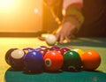 A close-up of a billiard table shows a set of colorful pool balls arranged in a triangle Royalty Free Stock Photo