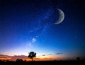 A serene night sky showcases a crescent moon and a vast array of stars, including the Milky Way Royalty Free Stock Photo