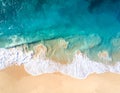 Aerial view of a beach with turquoise ocean waves gently washing onto a sandy shore Royalty Free Stock Photo