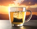 A clear glass mug filled with a light golden tea, contains a steeping tea bag Royalty Free Stock Photo