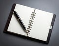 A leather-bound spiral notebook with blank white pages is open on a flat surface Royalty Free Stock Photo