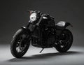 Black classic-style motorcycle on a grey studio backdrop Royalty Free Stock Photo