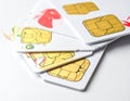 A stack of SIM cards with visible gold contacts on white plastic casings Royalty Free Stock Photo