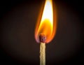 A close-up of a burning matchstick against a dark background Royalty Free Stock Photo