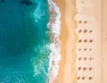 Aerial view of a beach with turquoise waves lapping against the sandy shore Royalty Free Stock Photo