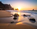 Golden sunset over Praia da Ursa in Portugal with soft waves washing onto the sandy beach Royalty Free Stock Photo