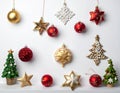 Christmas ornaments arranged on a white background include various red, gold, and white decorations Royalty Free Stock Photo