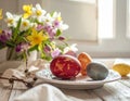 A white ceramic plate holds three dyed Easter eggs in shades of red, blue, and orange Royalty Free Stock Photo