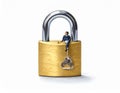 A miniature figure of a person, dressed in blue, sits on a large brass padlock Royalty Free Stock Photo