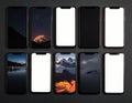 Nine smartphones are arranged in a 3x3 grid on a dark surface Royalty Free Stock Photo