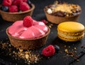 A selection of desserts displayed on a dark slate surface. In the foreground Royalty Free Stock Photo