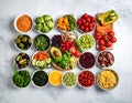 A vibrant assortment of colorful fruits, vegetables, and legumes arranged in bowls and on a wooden board Royalty Free Stock Photo