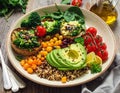 A colorful vegan Buddha bowl featuring sliced avocado, quinoa, cherry tomatoes on the vine Royalty Free Stock Photo