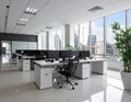 Modern office space with large windows offering a cityscape view. Features include rows of desks Royalty Free Stock Photo