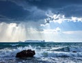 Generated Rough seas crash against a rocky shore under a dramatic, cloud-covered sky Royalty Free Stock Photo