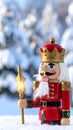Christmas Nutcracker King wearing crown and holding scepter, snow covered evergreen t Royalty Free Stock Photo