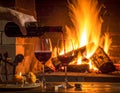 Art pouring wine by the fireplace Royalty Free Stock Photo