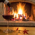 Art pouring wine by the fireplace Royalty Free Stock Photo