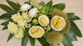 Exotic Fruits and Flowers Arrangement Durian, Green Leaves, Yellow Flowers, Wood Background Royalty Free Stock Photo