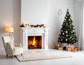 Cozy living room with a white fireplace adorned with lit candles and green garlands Royalty Free Stock Photo