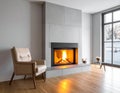 Modern living room features a sleek, gray fireplace with a glowing fire Royalty Free Stock Photo