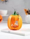 Cute artificial halloween orange pumpkin decoration made from paper and glass Royalty Free Stock Photo