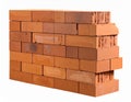 A small, incomplete wall consisting of evenly stacked red clay bricks with a rough texture Royalty Free Stock Photo