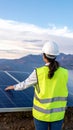 Woman engineer checking solar panels setup. Rear View Royalty Free Stock Photo