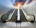 An upward-moving escalator between two smooth, metallic walls ascends towards a dramatic sky Royalty Free Stock Photo