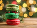 Beautifully decorated Christmas macarons on wooden table against blurred festive Royalty Free Stock Photo