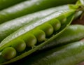 Macro close-up of fresh green peas inside an open pod. Royalty Free Stock Photo