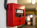 A red manual fire alarm box is mounted on a wall Royalty Free Stock Photo