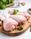 Board with raw chicken drumsticks on table, closeup. Fresh meat Royalty Free Stock Photo
