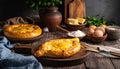 Delicious hachapuri filled with cheese and eggs, and a wooden table covered Royalty Free Stock Photo