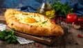 Delicious hachapuri filled with cheese and eggs, and a wooden table covered Royalty Free Stock Photo