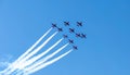 Team Of Red Airplanes Performing Aerobatic Maneuvers In Clear Blue Sky Royalty Free Stock Photo