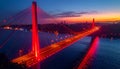 Cable-Stayed Bridge Illuminated Red At Dusk Over Water Royalty Free Stock Photo