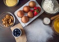 Assorted baking ingredients arranged on a dark wooden surface. Royalty Free Stock Photo